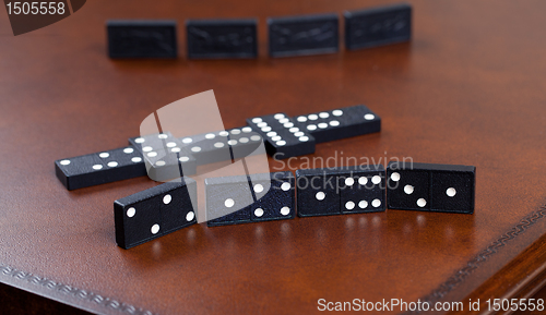 Image of Game of dominoes on leather table