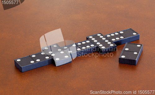 Image of Game of dominoes on leather table