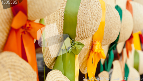 Image of Row of straw hats with ribbons