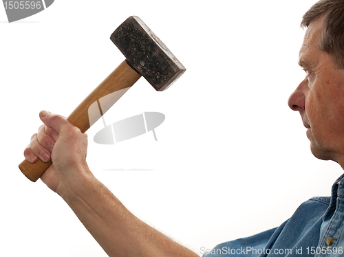 Image of Senior man holding a large hammer