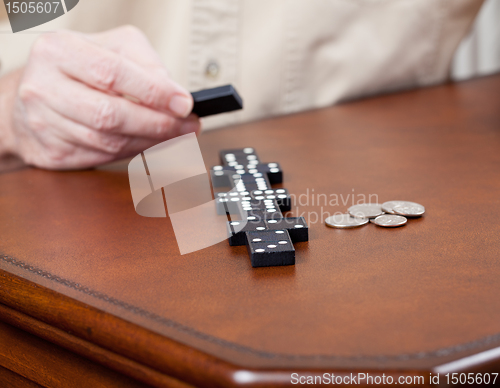 Image of Game of dominoes on leather table