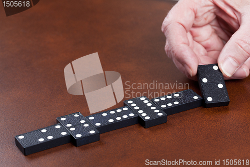 Image of Game of dominoes on leather table