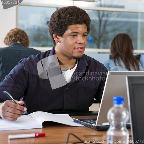 Image of Student behind laptop