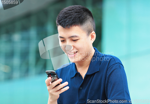 Image of Man typing message on phone