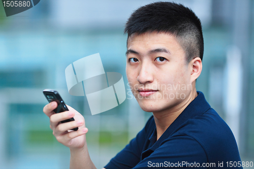 Image of Man typing message on phone