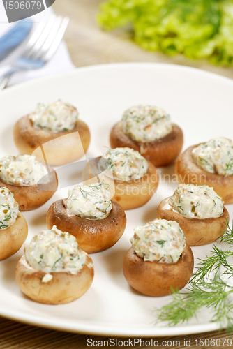 Image of stuffed champignon on white plate