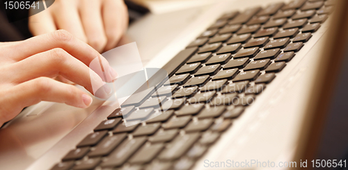 Image of Young woman working on laptop