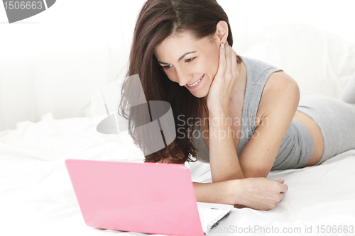 Image of young girl smiling at her computer close up