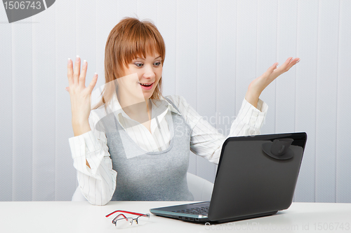 Image of Delighted girl looks at a monitor