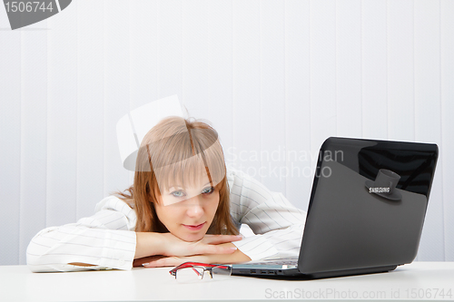 Image of Tired girl lies on a table