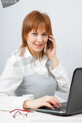 Image of Attractive happy girl in office