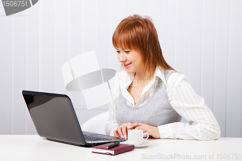 Image of smiling attractive girl with a notebook. Office worker