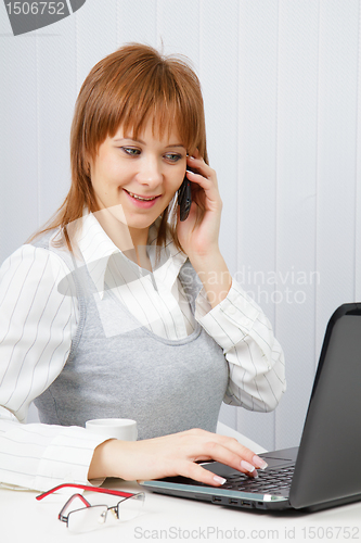 Image of Attractive happy girl in office