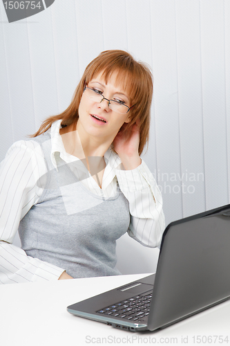 Image of tired girl with a laptop