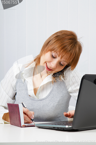 Image of Attractive happy girl in office
