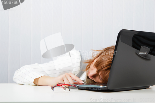 Image of Tired girl lies on a table