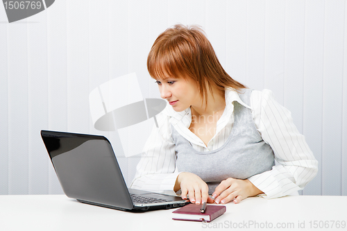 Image of smiling girl with a notebook