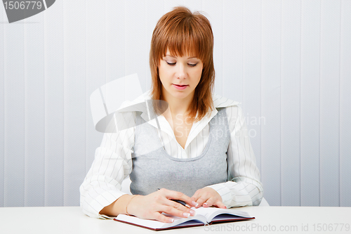 Image of Attractive girl with a notepad and pen