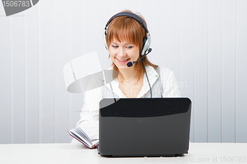 Image of girl with laptop in headphones