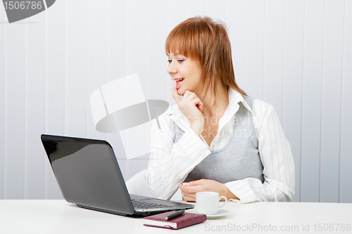 Image of smiling attractive girl with a notebook