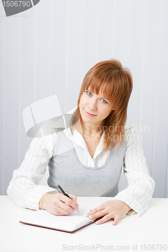 Image of Attractive girl with a notepad and pen