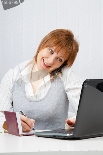 Image of Attractive happy girl talking on the phone