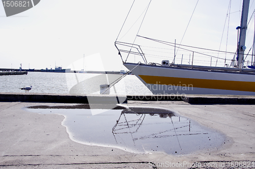 Image of Yacht resting moored at port. Seagull and pier.