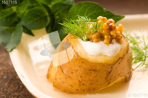 Image of Baked potato with sour cream, grain Dijon mustard and herbs