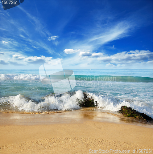 Image of stones in the waves on ocean coast