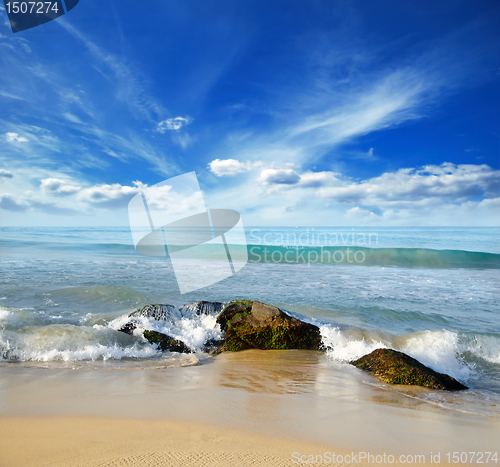 Image of stones in the waves on ocean coast