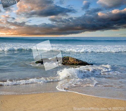 Image of stones in the waves on ocean coast