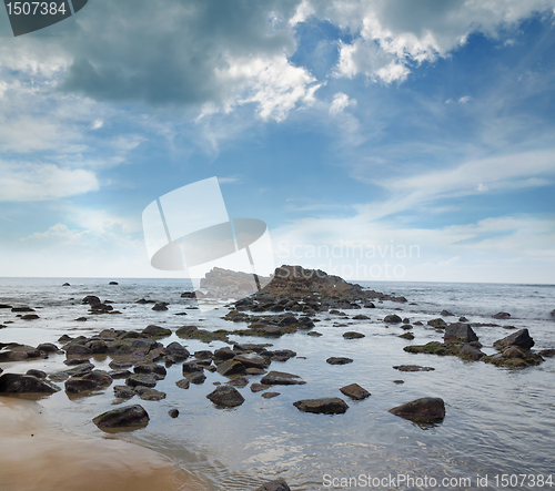 Image of stones in the waves on ocean coast