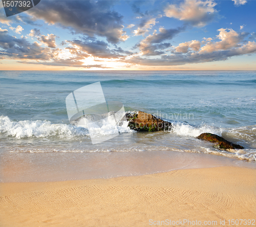 Image of stones in the waves on ocean coast