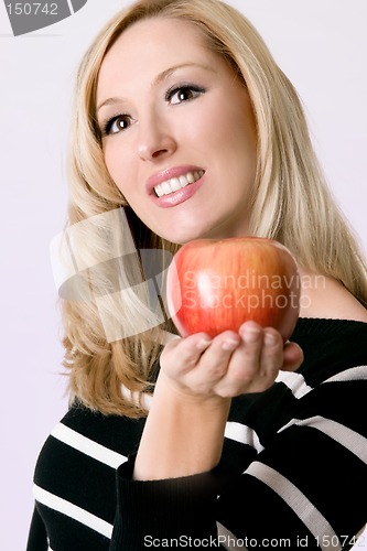 Image of Female holding a fresh red apple
