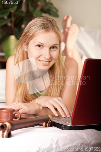 Image of woman in bed with laptop
