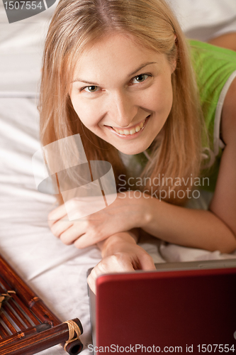 Image of woman in bed with laptop