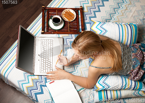 Image of woman in bed with laptop