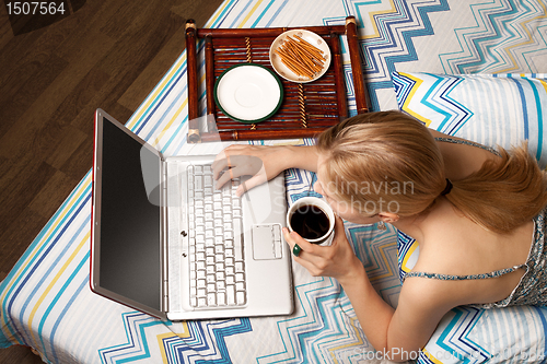 Image of woman in bed with laptop