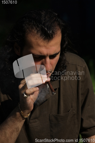 Image of Person Smoking a Cigar