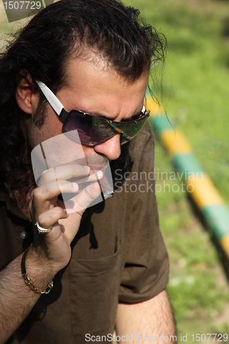 Image of Person Smoking a Cigar