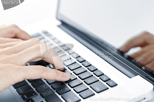 Image of Hands typing on laptop keyboard