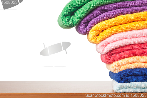 Image of Stack of colorful microfiber towels toppling