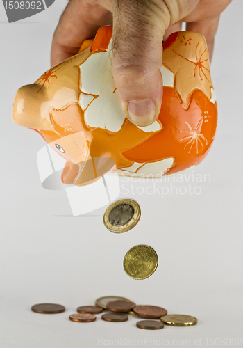 Image of piggy bank with falling coins