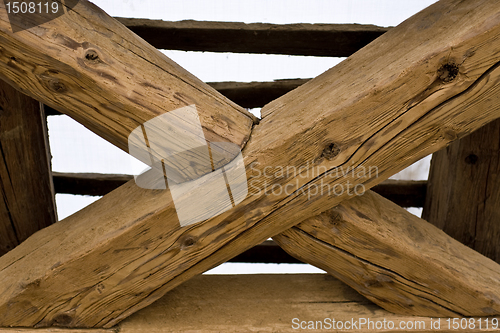 Image of wooden cross in old roof