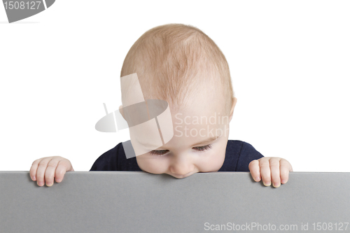 Image of young child holding blank grey cardboard