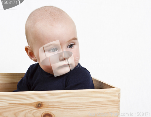 Image of toddler in wooden box