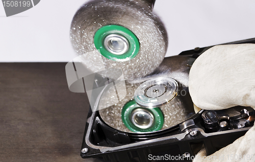 Image of cleaning data from hard disk with steel brush