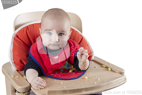 Image of toddler eating potatoes