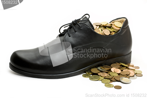 Image of black business shoe with money