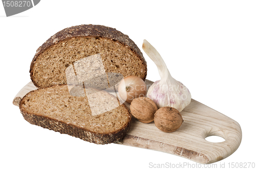 Image of brown bread on shelf with onion, garlic and walnut